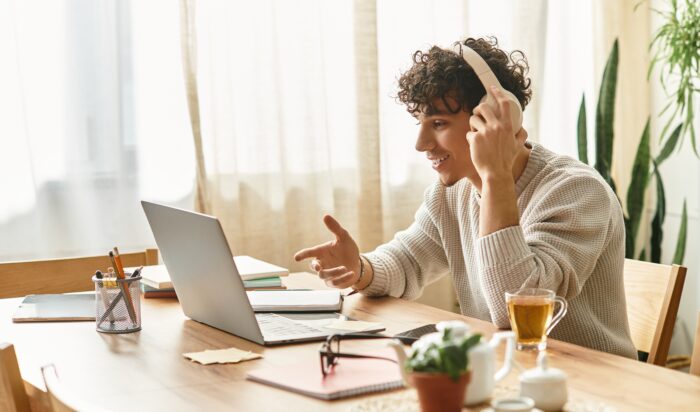 Charming,Young,Man,Engages,Enthusiastically,While,Working,On,His,Laptop Charming,Young,Man,Engages,Enthusiastically,While,Working,On,His,Laptop